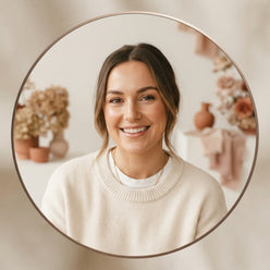 Portrait of influencer Victoria Garrick smiling in a clean, professional setting with soft warm lighting.